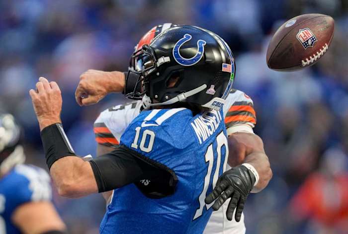 Gardner Minshew is sacked by Myles Garrett as the ball flies through the air behind them being knocked out of his hand